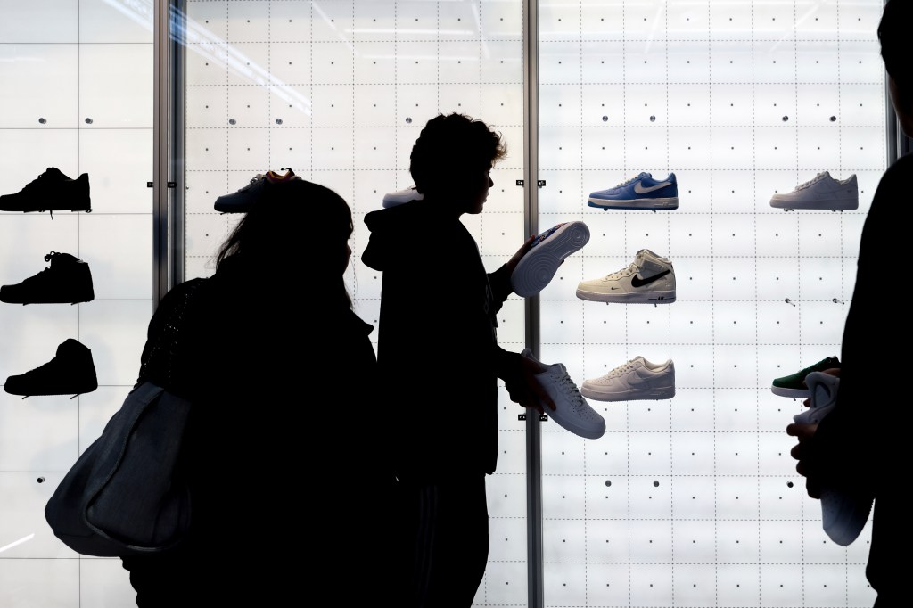 People buy shoes at a Nike store in November. 25, 2022, in New York.